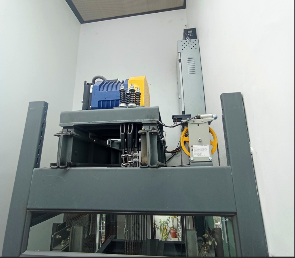 The hoist and cable pulley system of a home elevator is installed in the elevator shaft.