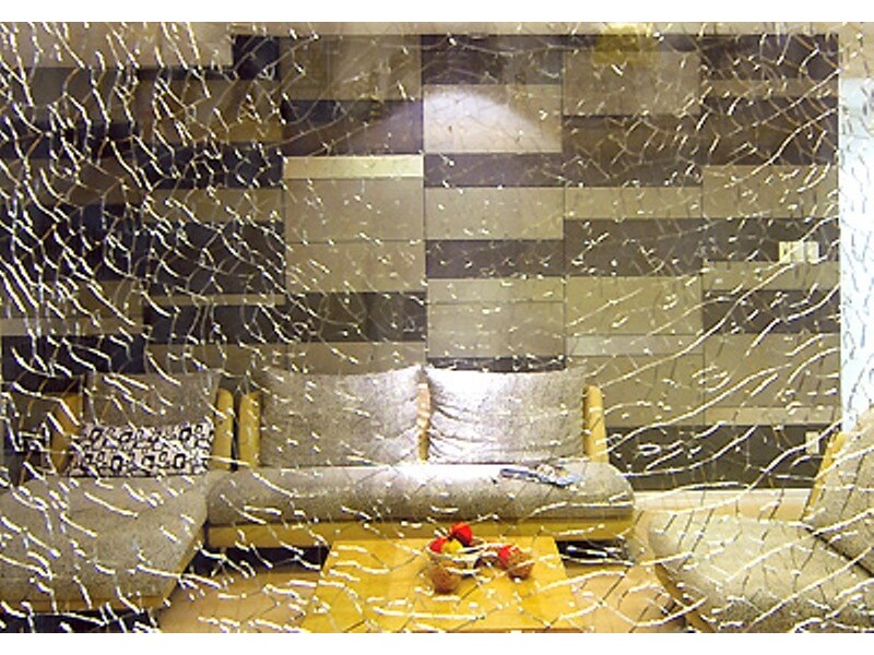 Decorative patterned tempered glass for the living room, featuring a modern sofa and coffee table set.